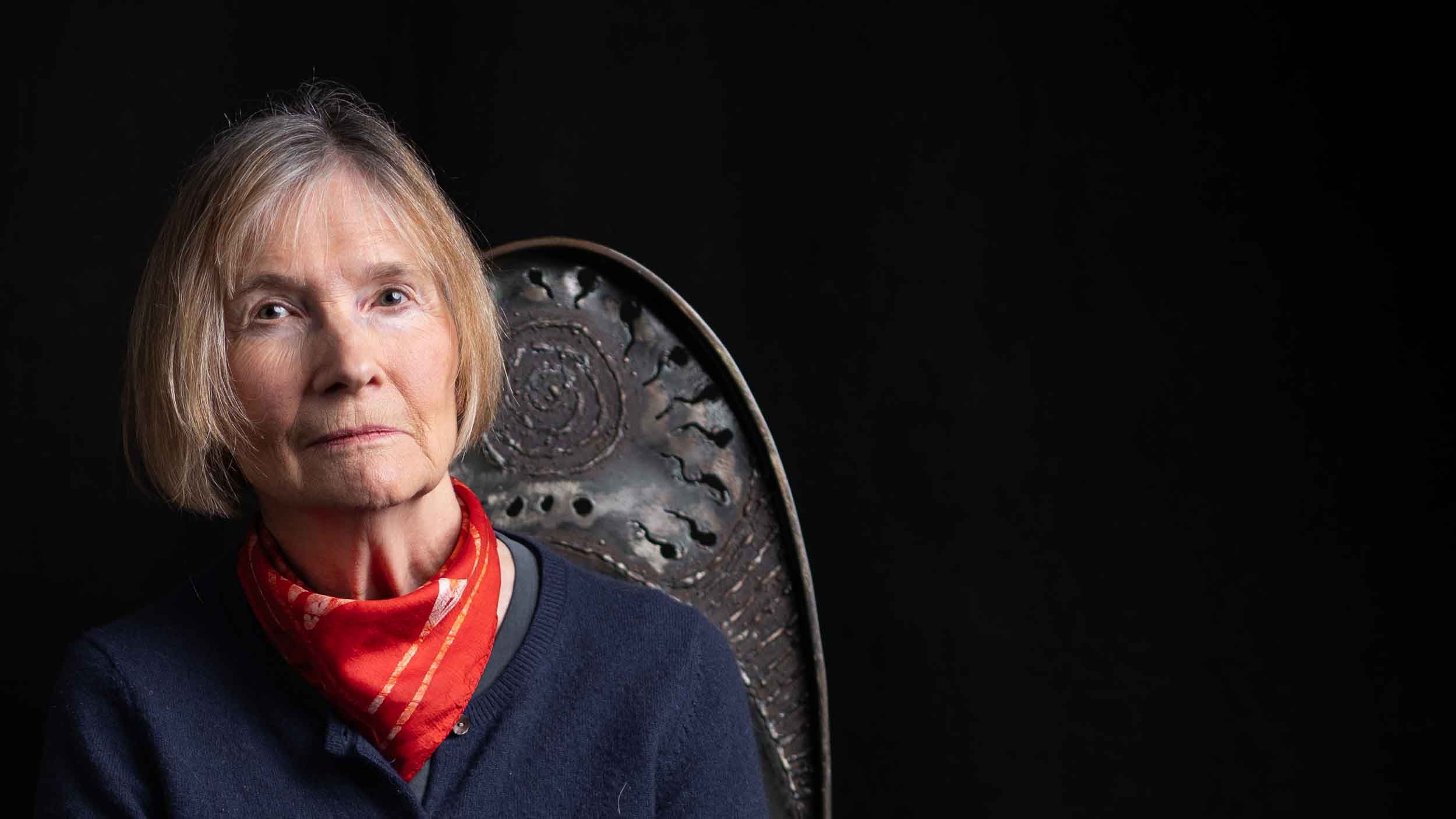 Closeup of author Danuta Reah, who has also written as Danuta Kot and Carla Banks, sitting in a chair